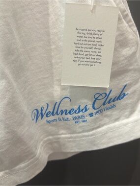 Sporty & Rich Wellness Club White Tee with Light Blue Script